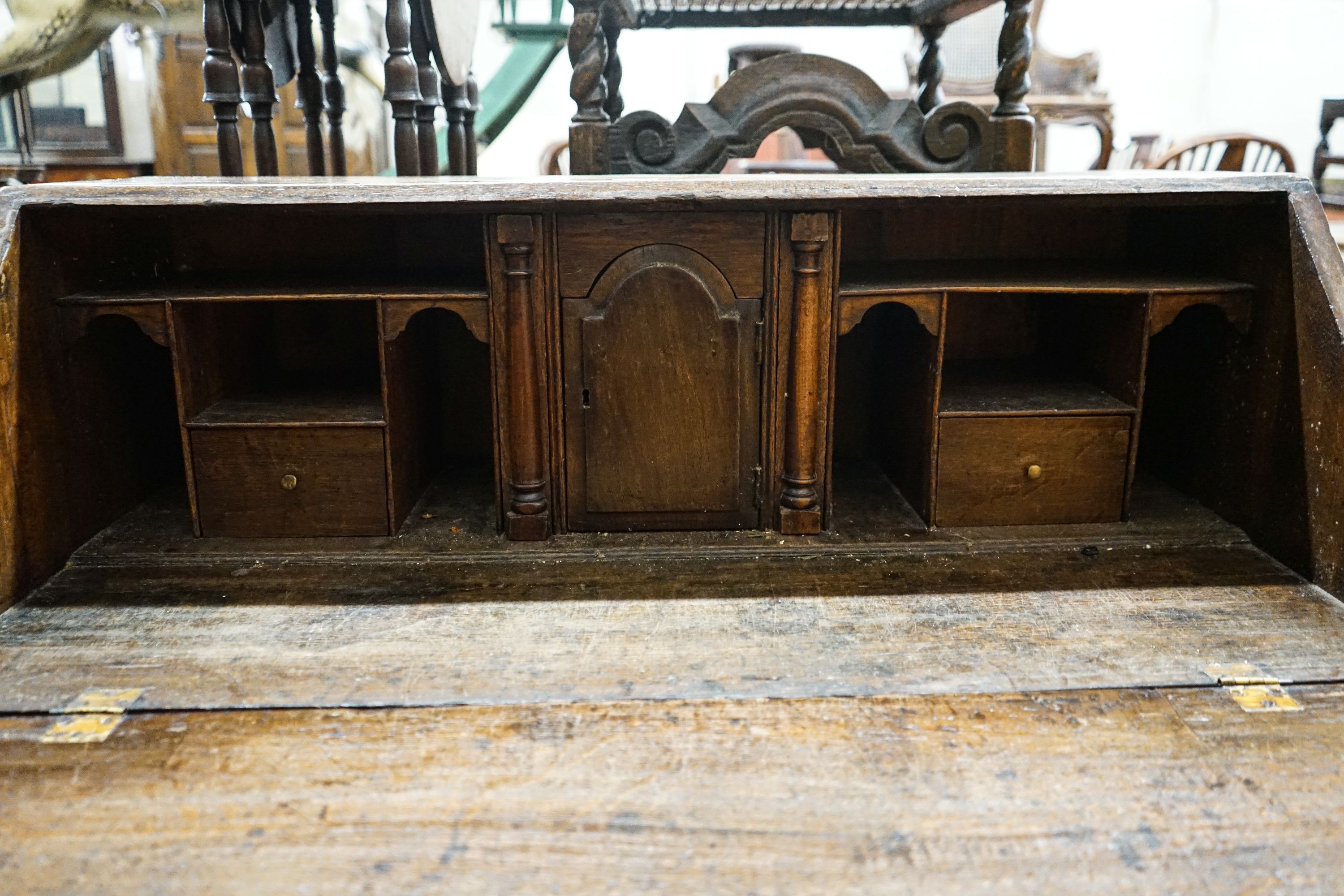 A George III oak bureau, with fitted interior, two short and three long drawers, width 92cm, depth 50cm, height 100cm